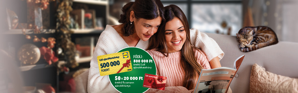 A képen két fiatal hölgy oldas egy magazin egy macska társaságában.